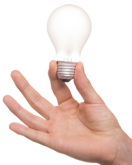 hand holding a clear lightbulb
