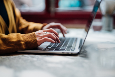 Image of hands working at a laptop